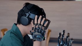 4K, Asian boy wearing 3D ride on head covers eyes, look at be realistic visual player, have hand tools and  hand-operated robot It is technology for helping people with disabilities.