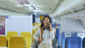 A cute Asian teenage girl is talking on the phone with a friend while on a plane for her annual vacation, traveler concept