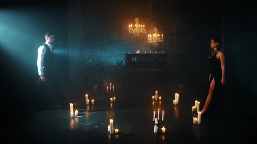 Two person fall in love Happy sexy couple dancing man and blonde woman spinning. Gothic Girl passion dancer in Black evening dress. Portrait Guy fantasy prince Fashion model. dark carnival party room 