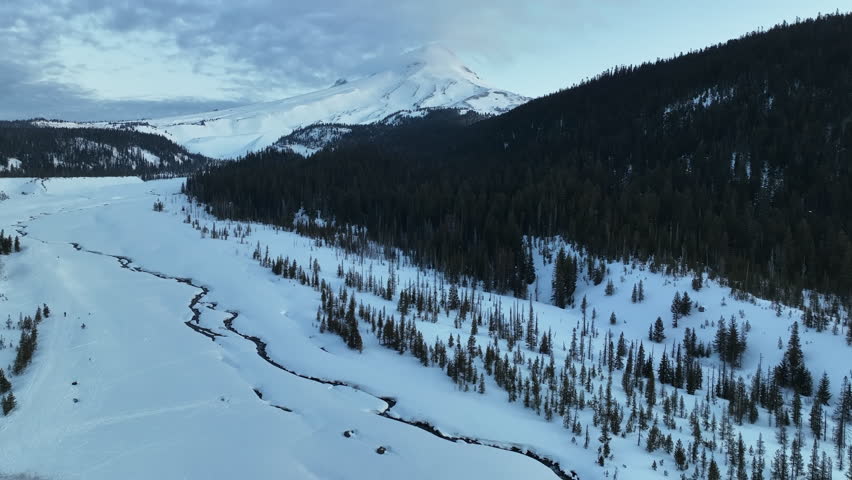 Early morning light shines on Mt Hood, an iconic stratovolcano found about 50 miles southeast of Portland, Oregon. Mt Hood has one of the longest ski seasons in the U.S. due to its annual snow pack.