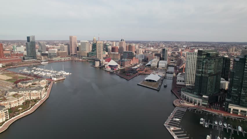Side-moving drone shot, Baltimore Inner Harbor, rich colors of the downtown cityscape. 4K