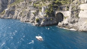 Aerial video of a red boat in the background of the stone arch bridge of Furora Fiord, Amalfi Coast, Italy - Powered by Shutterstock - Get 15% off with code: PIKWIZARD15