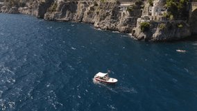Aerial video of a red boat in the background of the stone arch bridge of Furora Fiord, Amalfi Coast, Italy - Powered by Shutterstock - Get 15% off with code: PIKWIZARD15