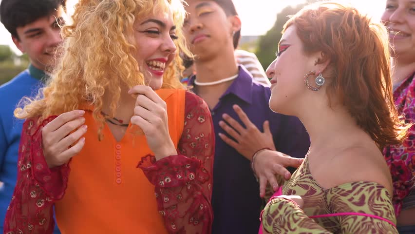 Group of multiracial young people dancing together at music concert outdoor during summer time 
