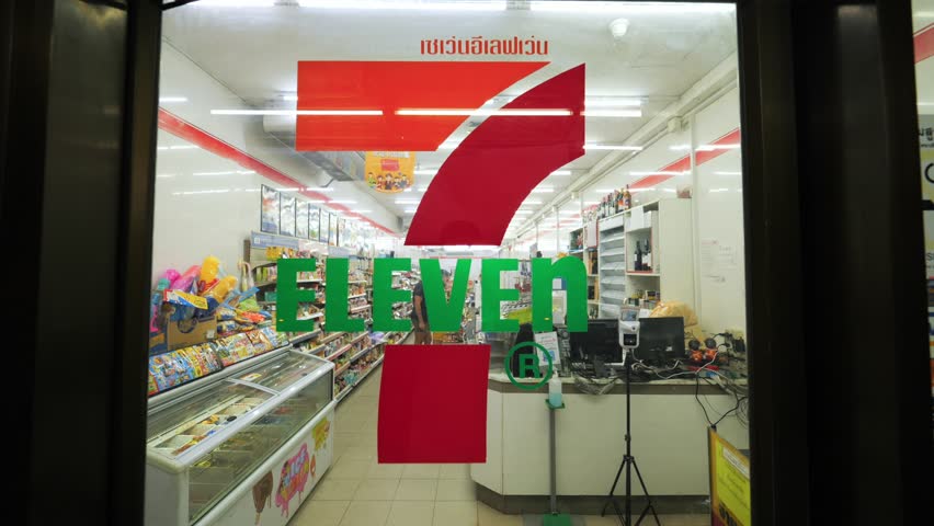 Walks into 7-eleven shop first person view 4K slow motion door opens shopping concept. 30 MAR 2023 Chiang Mai, Thailand.