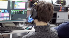 Video engineer in the process of working at his computer.