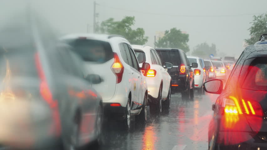 Traffic jams caused by bad stormy weather view from inside the car. Rain Drops on Windshield During Storm. | Shutterstock HD Video #1102001265