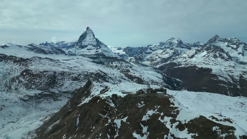 Aerial drone view of Matterhorn mountain peak observatory in winter in Switzerland  Royalty-Free Stock Footage #1102002889