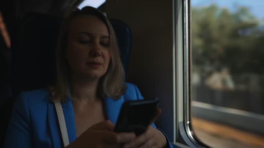 Woman in business suit travelling by the train.