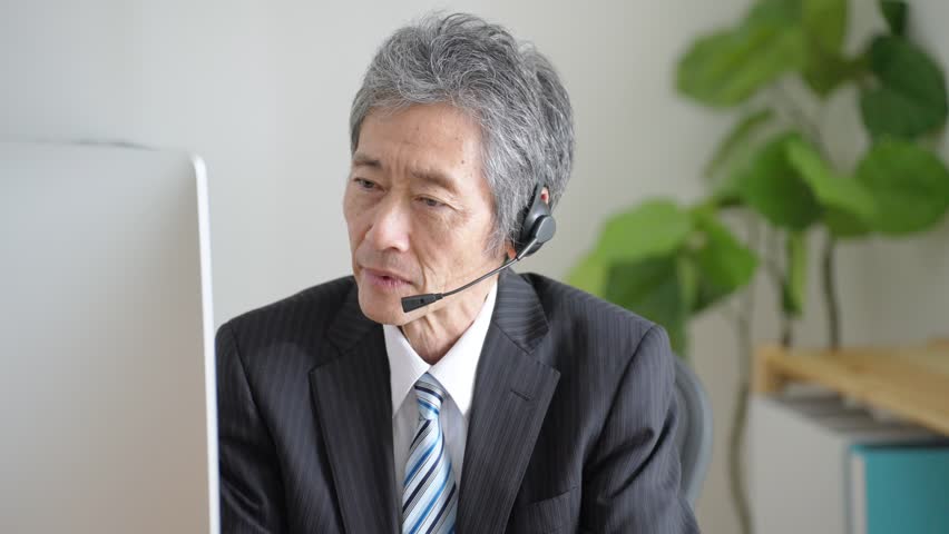 Elderly businessman working in office | Shutterstock HD Video #1102004403