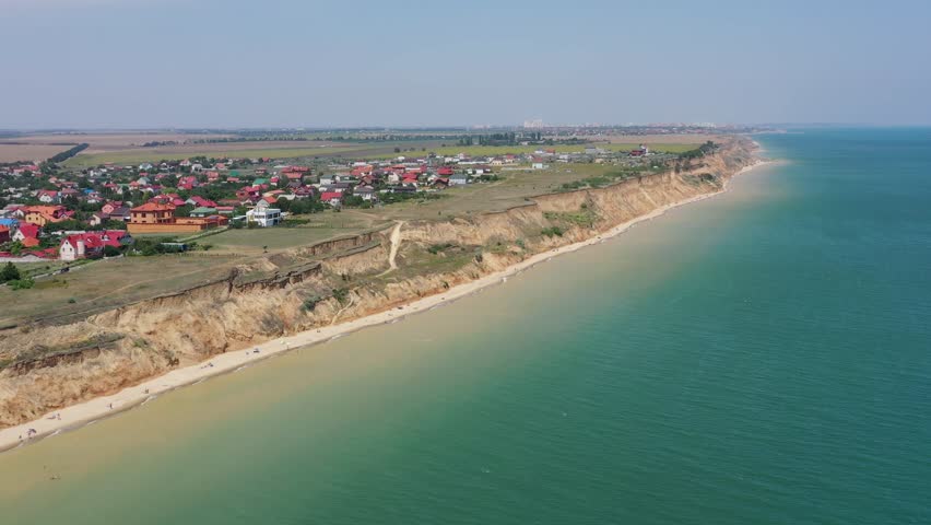 Panorama of sea shore in South Ukraine, Europe. Resort city with nice sand beach and clear blue sea. travel destination, ideal place for comfort vacation on black Sea. Drone video.