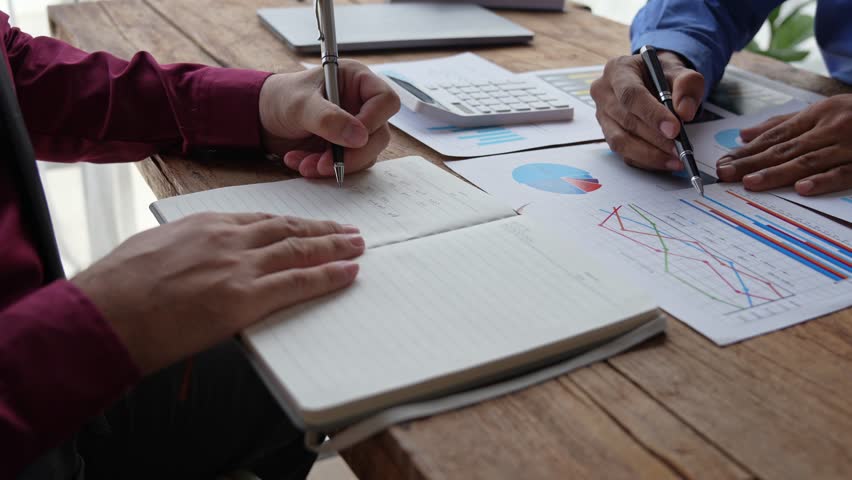 Financial analyst analyzes business finance reports on laptop and graph documents during corporate meeting discussions showing successful teamwork, business meeting ideas, marketing. | Shutterstock HD Video #1102008767