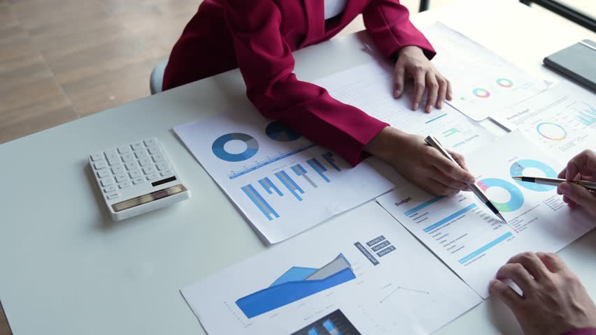 Financial analyst analyzes businessman investment consultant analyzing company financial report balance sheet statement working with documents graphs. Concept picture for stock market, office, tax | Shutterstock HD Video #1102008781