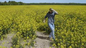 Happy Man Farmer Dancing Enjoying at Rape Blossom On Field. Fun Celebrating Funny Viral Dance Freedom. Guy Enjoying Dance. Joyful Man Farmer Dancing. Flowering Rapeseed Field Blue Sky. - Powered by Shutterstock - Get 15% off with code: PIKWIZARD15
