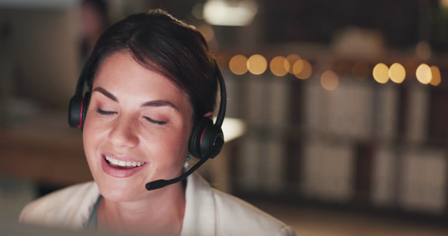 Call center, explain or happy woman in telecom, customer services or communications company. Communication, friendly girl or sales agent with microphone at crm or technical support office at night | Shutterstock HD Video #1102018743