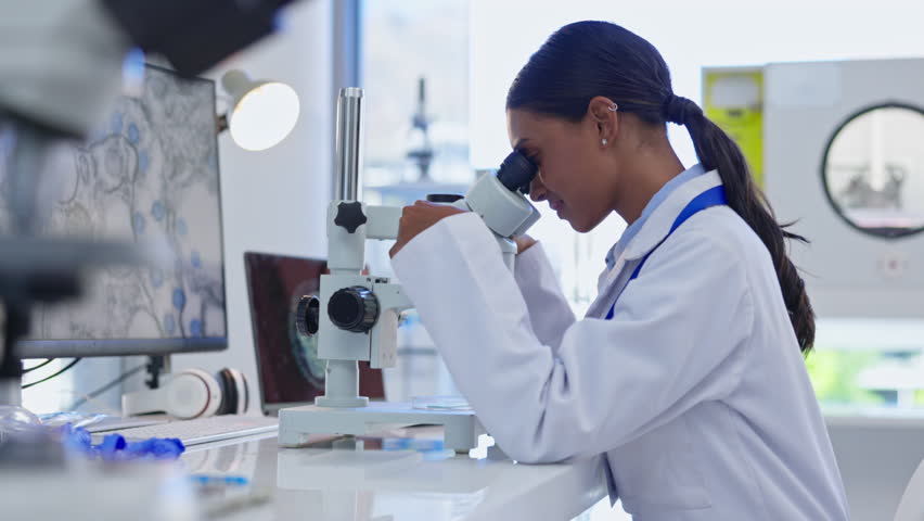 Medical, microscope check and woman scientist doing research for dna and laboratory work for science. Lab worker, analytics and biotechnology of a clinic employee working on health development | Shutterstock HD Video #1102018931