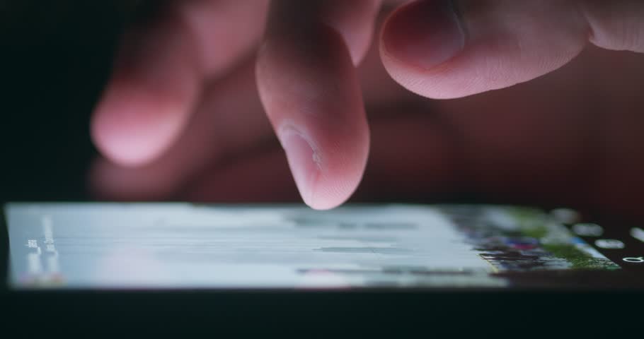 Closeup macro shot of person finger scroll phone screen social networks at night time. Male finger scroll mobile screen app on phone surf internet web pages, social media. Concept of using smart phone Royalty-Free Stock Footage #1102021167