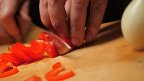 Chef cutting red pepper with a knife. - Powered by Shutterstock - Get 15% off with code: PIKWIZARD15