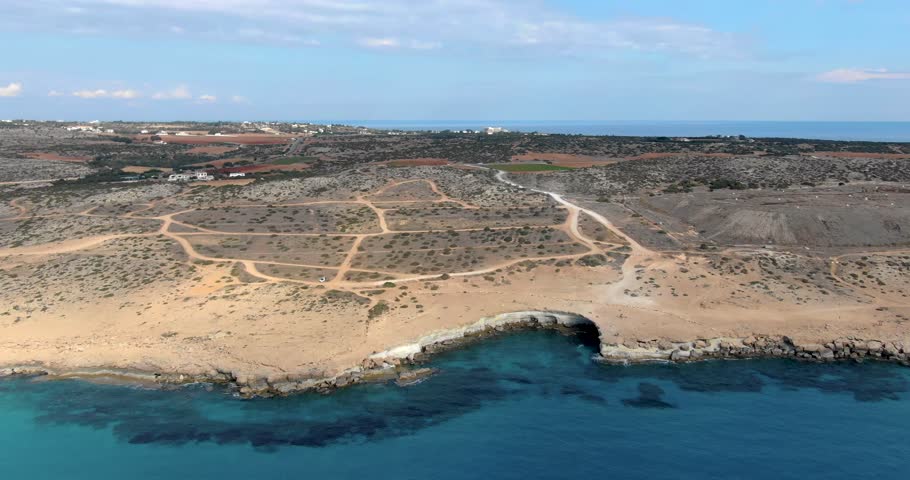 Copter flight over the high slope of the island with panoramic views of the city with houses, infrastructure and wildlife in Cyprus.