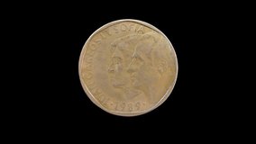 Obverse of Spain coin 500 pesetas 1989 with family portrait of king Juan Carlos I and his wife Sofia, isolated in black background. 4k video