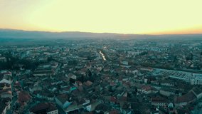 Footage of the medieval city center of Sibiu, Romania. The video was shoot from a drone at sunset while flying backwards next to the Cathedral with the camera level for a panoramic view.