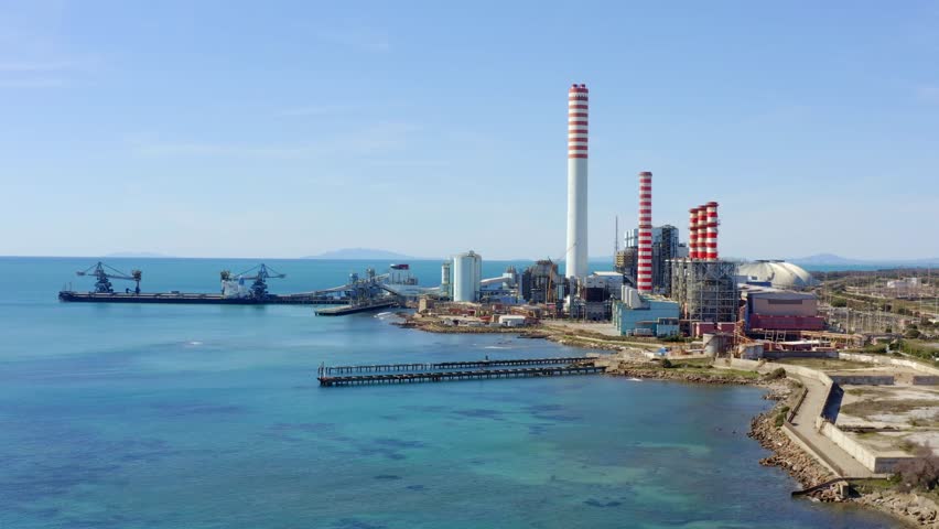 Aerial view on a large thermal power plant built along the coasts of the Mediterranean sea in Civitavecchia, near Rome, Italy.