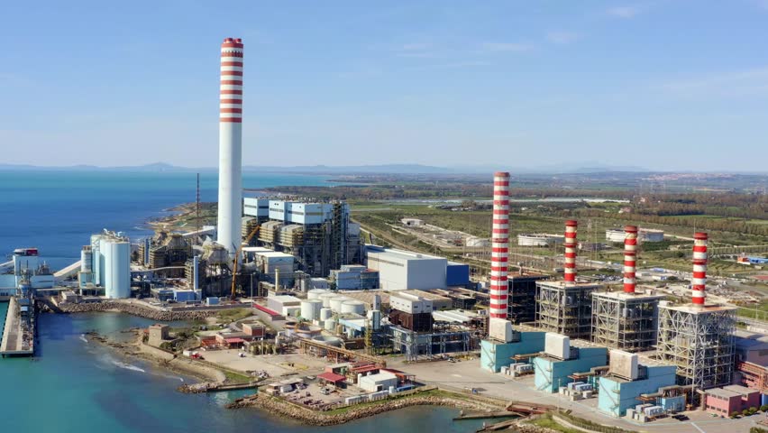 Aerial view on a large thermal power plant built along the coasts of the Mediterranean sea in Civitavecchia, near Rome, Italy.