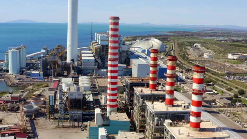 Aerial view on a large thermal power plant built along the coasts of the Mediterranean sea in Civitavecchia, near Rome, Italy.