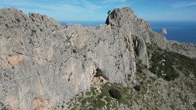 Aerial footage shows the breathtaking Serra de Bernia mountains, featuring rugged terrain, winding trails, and panoramic views of the surrounding Costa Blanca region.Serra de Bèrnia,Alicante, Spain.