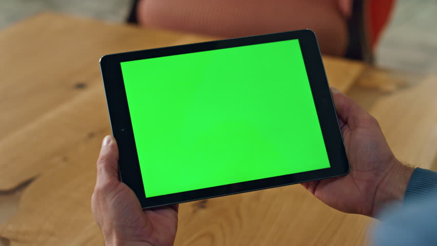 User holding chromakey computer indoors closeup. Unrecognized man reading template device email at office alone. Elegant businessman hands using green screen tab at workplace. Technologies concept Royalty-Free Stock Footage #1102032329