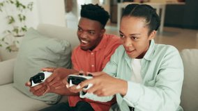 Happy gaming couple on video game console in the living room or home sofa for win, challenge and esport lifestyle. Excited gen z black people or gamer friends with online action and fun competition