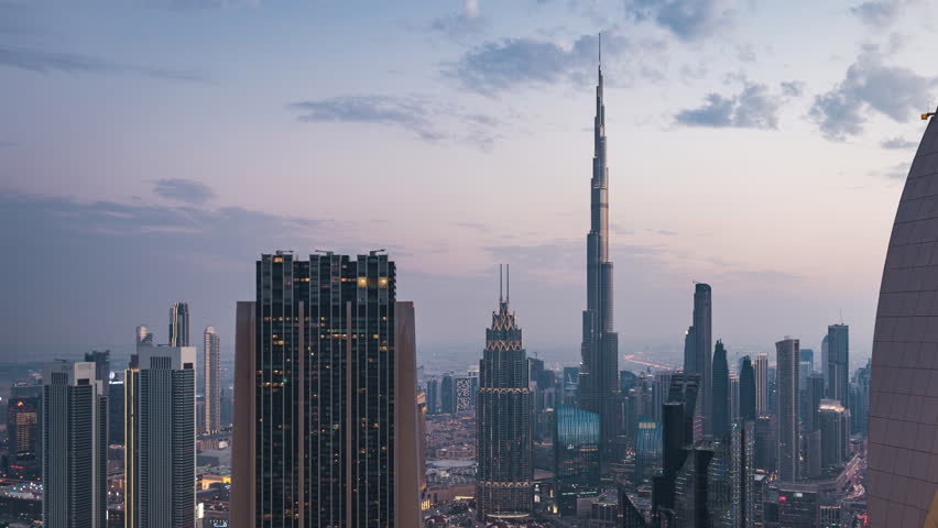 Day to night timelapse view of skyscrapers in Downtown Dubai, United Arab Emirates (UAE), business and finance concept, modern cities and skylines.