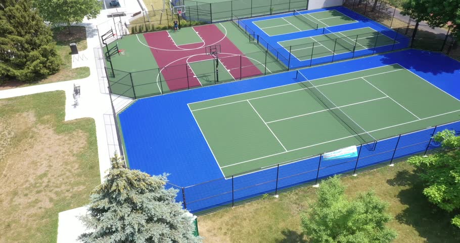 Suburban park with tennis, pickleball and basketball courts and a hockey rink.