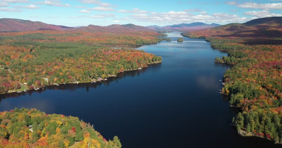 Aerial view of 14 mile long Long Lake in Adirondack Park during the height of autumn in Upstate New York.