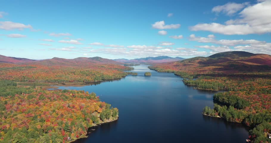 Aerial view of 14 mile long Long Lake in Adirondack Park during the height of autumn in Upstate New York.