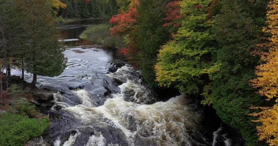 Aerial view of Buttermilk Falls with beautiful fall colors near Long Lake in the Adirondacks of Upstate New York during autumn.