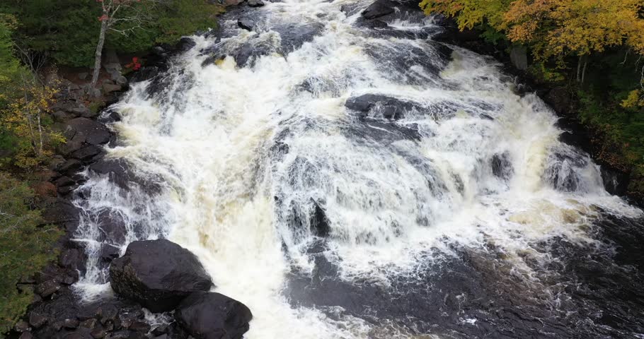Aerial view of Buttermilk Falls with beautiful fall colors near Long Lake in the Adirondacks of Upstate New York during autumn.