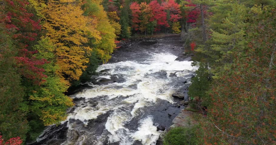 Aerial view of Buttermilk Falls with beautiful fall colors near Long Lake in the Adirondacks of Upstate New York during autumn.