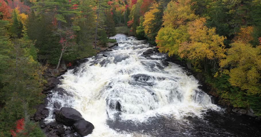 Aerial view of Buttermilk Falls with beautiful fall colors near Long Lake in the Adirondacks of Upstate New York during autumn.