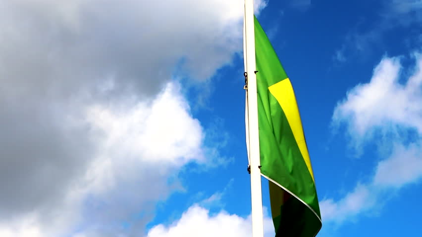 Flag of Brazil. The Brazilian flag on a flagpole at the background blue sky with beautiful clouds. In Brazil their national flag is called Bandeira do Brasil.  Waving Brazil Flag, 4K video | Shutterstock HD Video #1102042409
