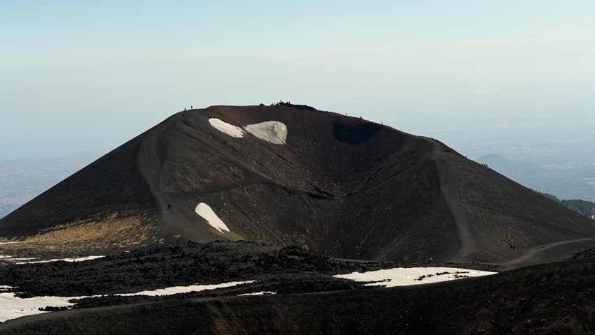 Wonderful timelapse of hikers on Etna volcano. Tourists walk along the edge of a huge volcanic crater. Silvestri craters, Sapienza refuge. Hard trails in high mountains, people climbing up and down.