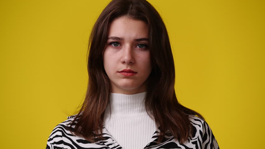4k video of one girl feeling bad over yellow background. | Shutterstock HD Video #1102047255
