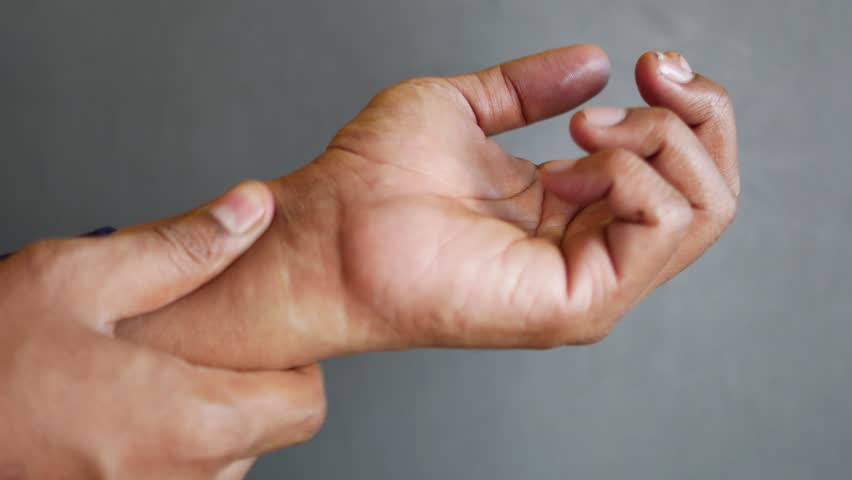 Man suffering pain in hand close up  | Shutterstock HD Video #1102047693