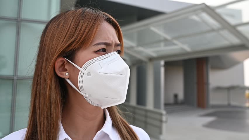Asian woman wear N95 mask for protect dust pm 2.5,ecology concept. Allergy, headache. air danger in city. | Shutterstock HD Video #1102048313