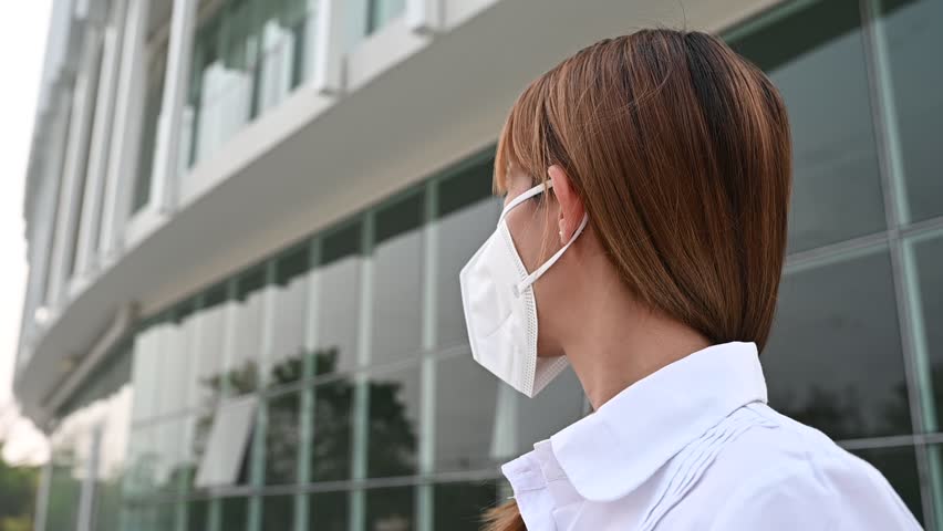 Asian woman wear N95 mask for protect dust pm 2.5,ecology concept. Allergy, headache. air danger in city. | Shutterstock HD Video #1102048319