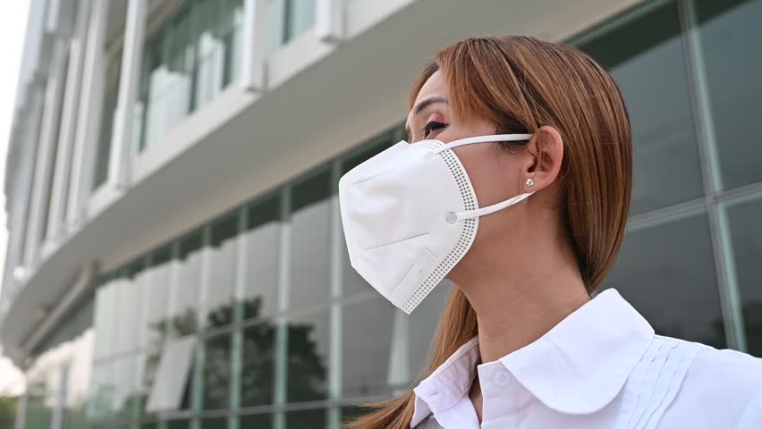 Asian woman wear N95 mask for protect dust pm 2.5,ecology concept. Allergy, headache. air danger in city. | Shutterstock HD Video #1102048321