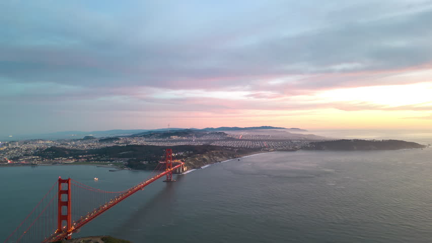 Time Lapse: Pink sunset sky over San Francisco cityscape as day becomes night