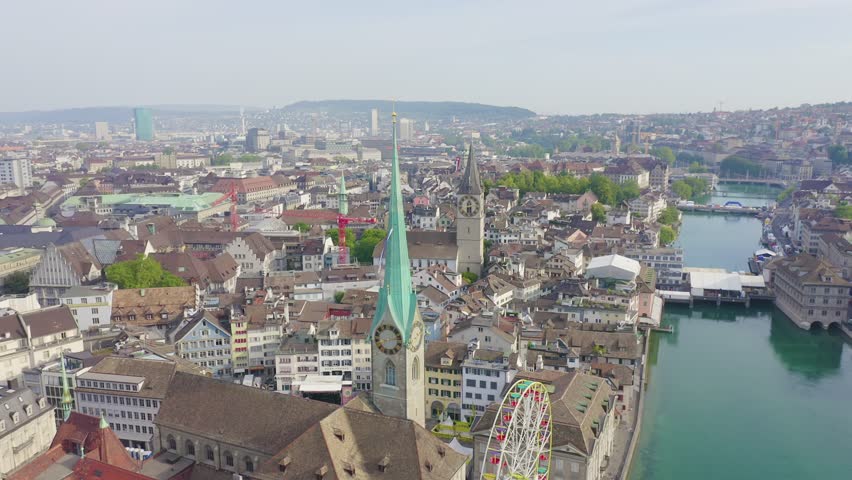 Inscription on video. Zurich, Switzerland. Panorama of the city from the air. Fraumunster Church. Multicolored text appears and disappears, Aerial View, Point of interest