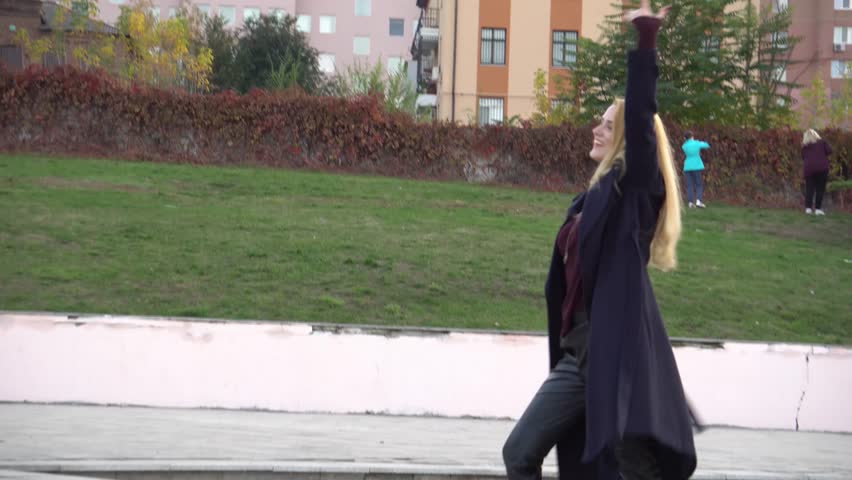 4K Girl listening to music in the street and dancing