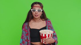 Excited young woman in 3D glasses eating popcorn and watching interesting tv serial, sport game, film, online social media movie content. Hippie girl isolated on chroma key background, green screen